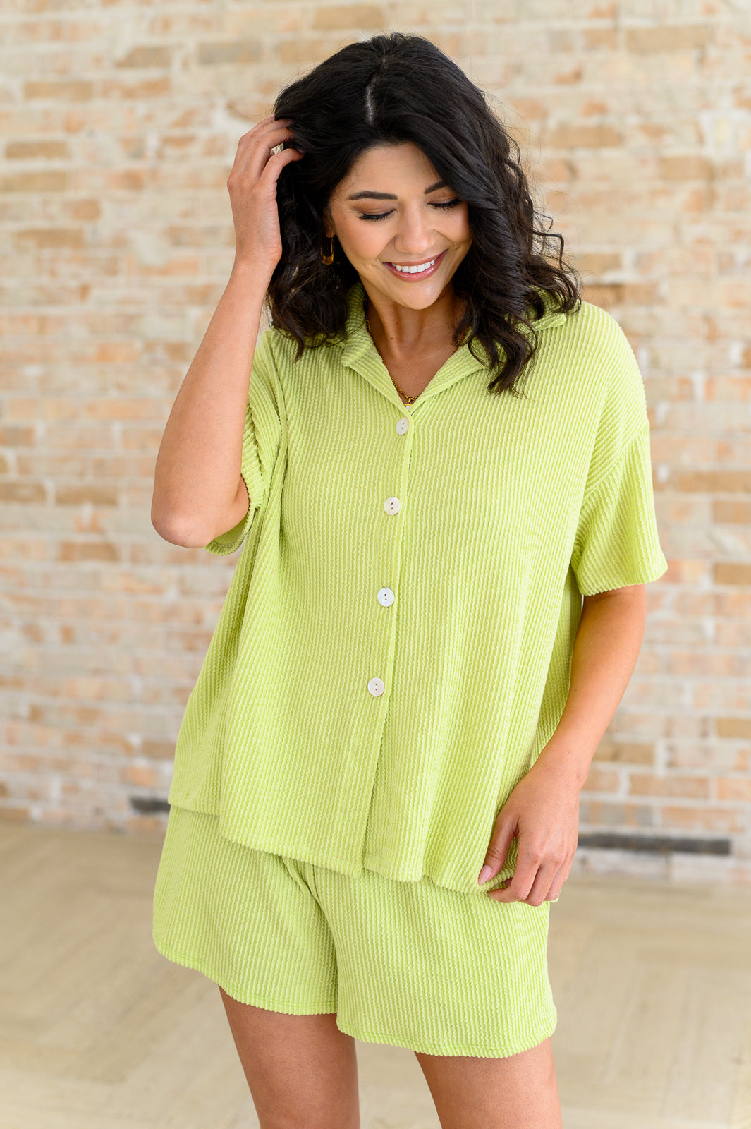 Model wearing Townes Ribbed Button Down Shirt and matching shorts set in pear green, relaxed textured knit