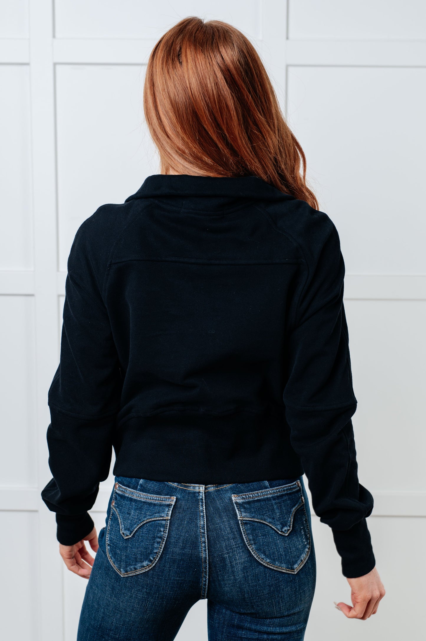 Back view of Sara Half Zip Pullover in black highlighting raglan seam detail.