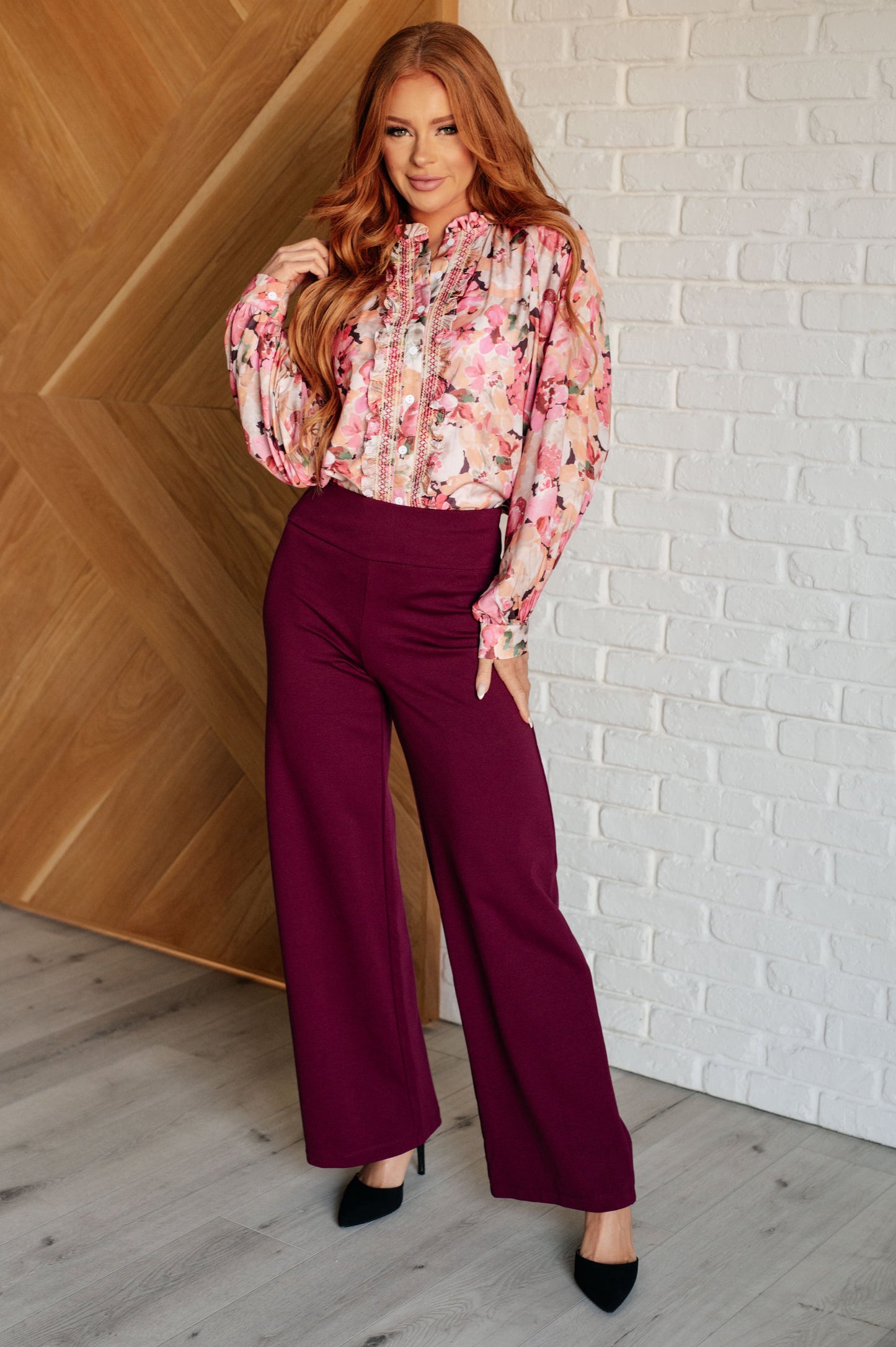 Ulyana Floral Blouse in pink poly satin with button front, styled for the office.