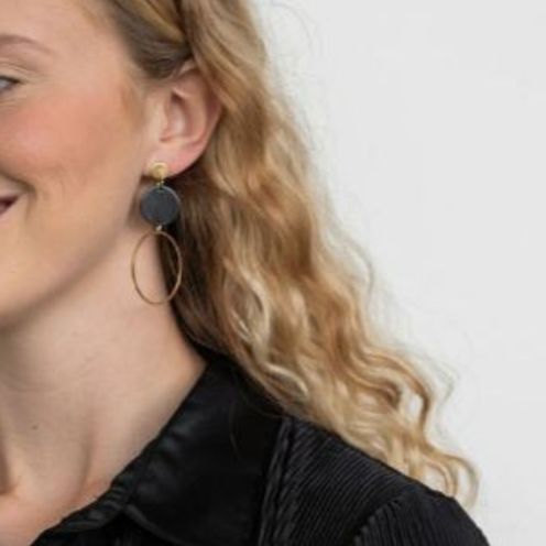 Woman wearing Sadie Earrings – Black with gold-plated charm detail.