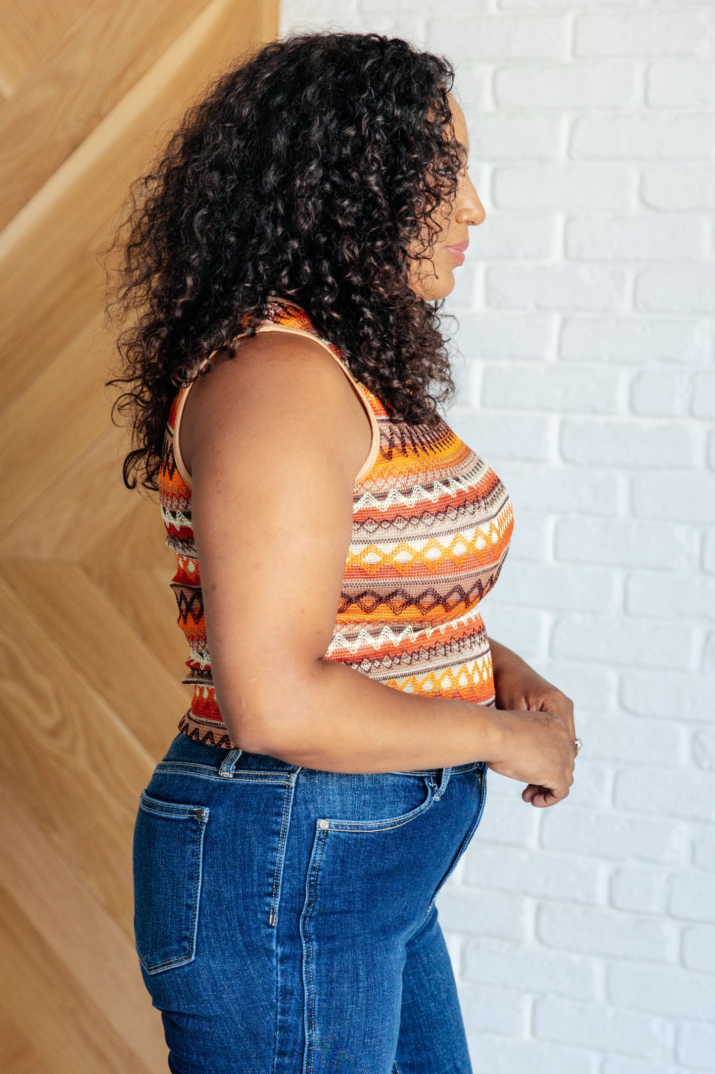Fashion-forward plus size sleeveless knit tank, perfect for adding a pop of color with its unique geometric design.