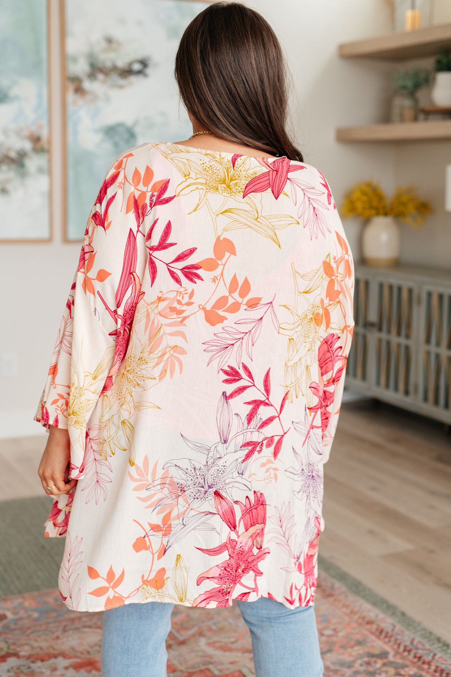 Plus size model back view of Mei Bell Sleeve Kimono, floral print with relaxed drape.