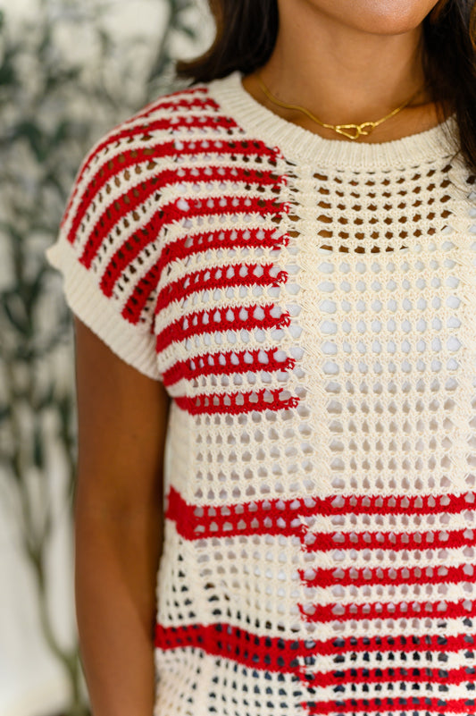 Close-up of a lightweight net knit red striped tee with relaxed dolman sleeves and comfy stretch fit.