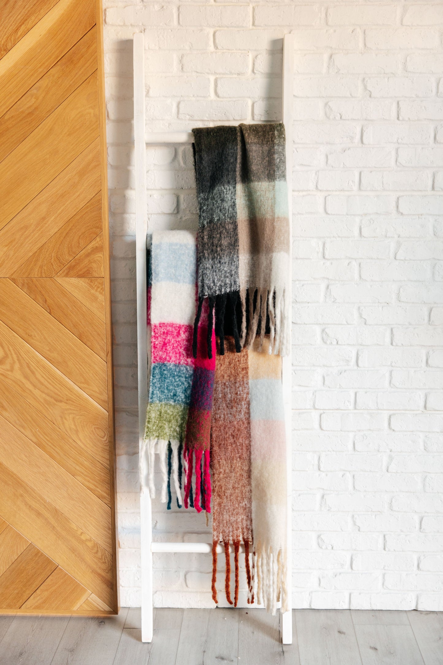 Flat lay of Wanderlust Wrap Oversized Plaid Fringe Scarf with 53-inch length and fringe.