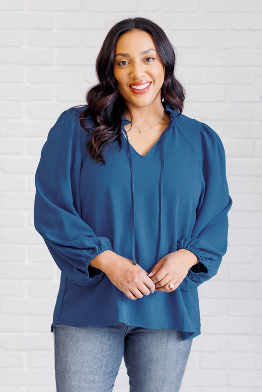 Plus size front view of Vesper Keyhole Tie Blouse with self-tie keyhole closure and ruffle detail.