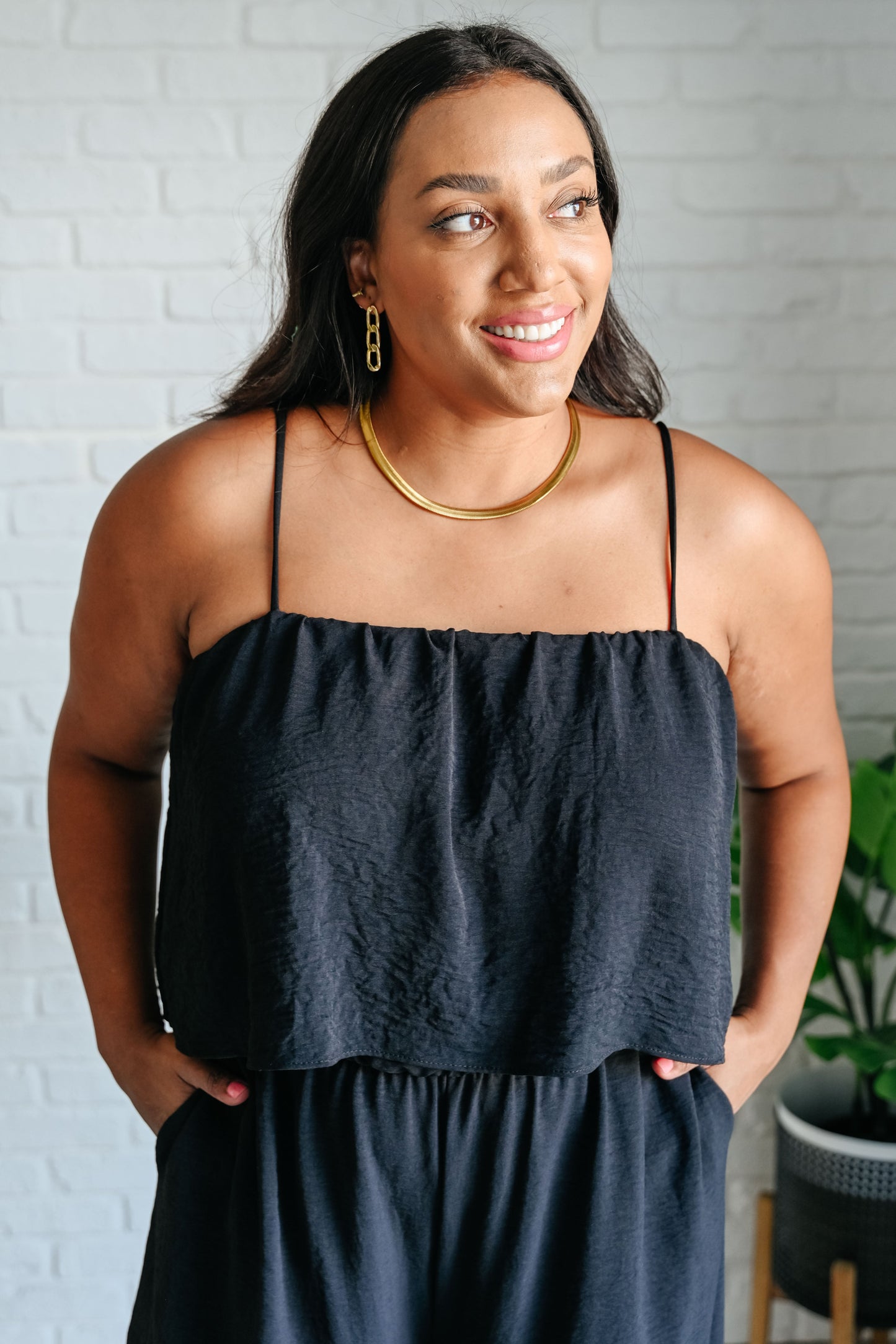 Close-up of Sahar Black Spaghetti Strap Jumpsuit highlighting tiered bodice and elastic neckline.