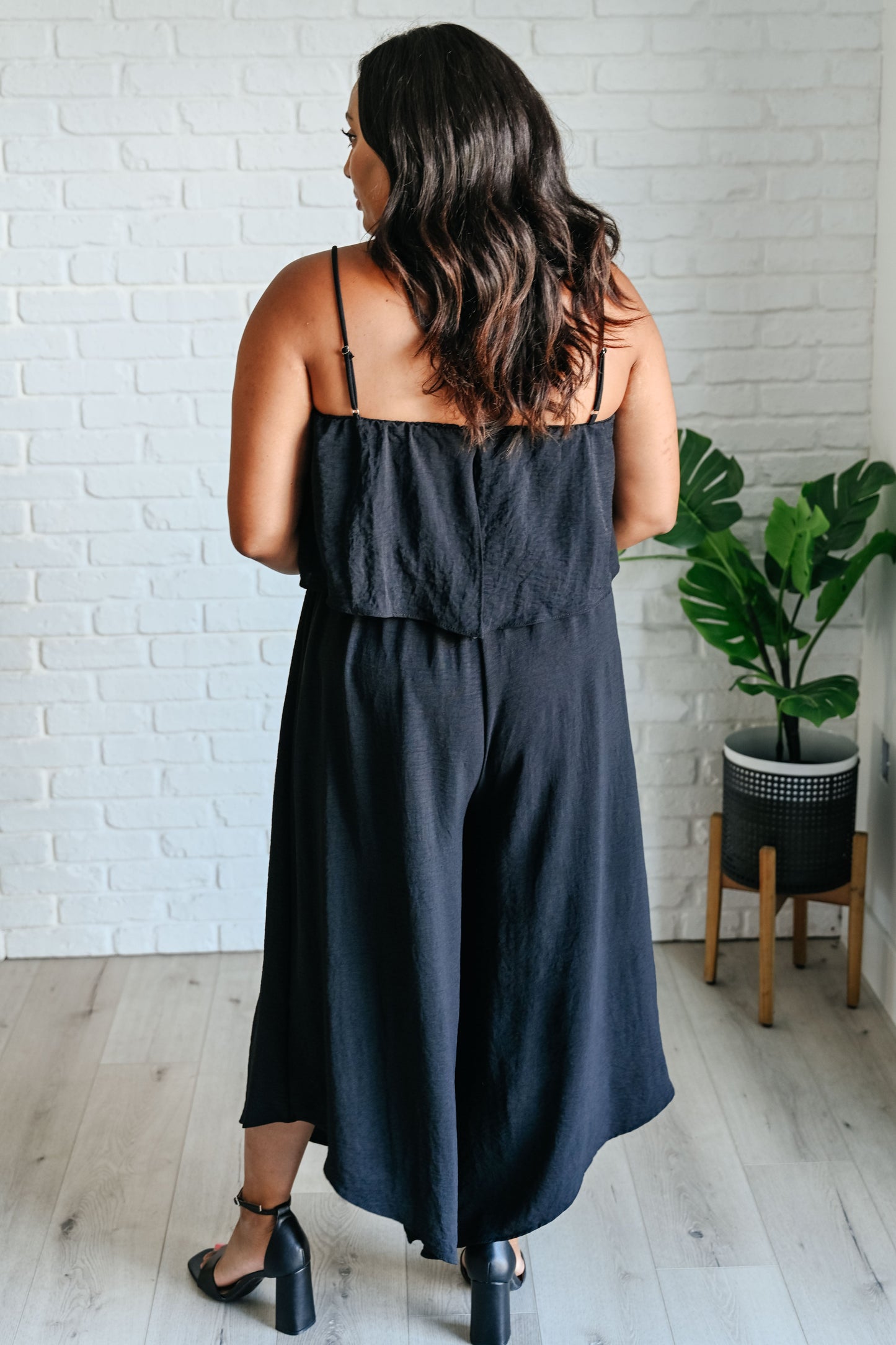 Plus size back view of Sahar Black Jumpsuit highlighting relaxed wide-leg silhouette.