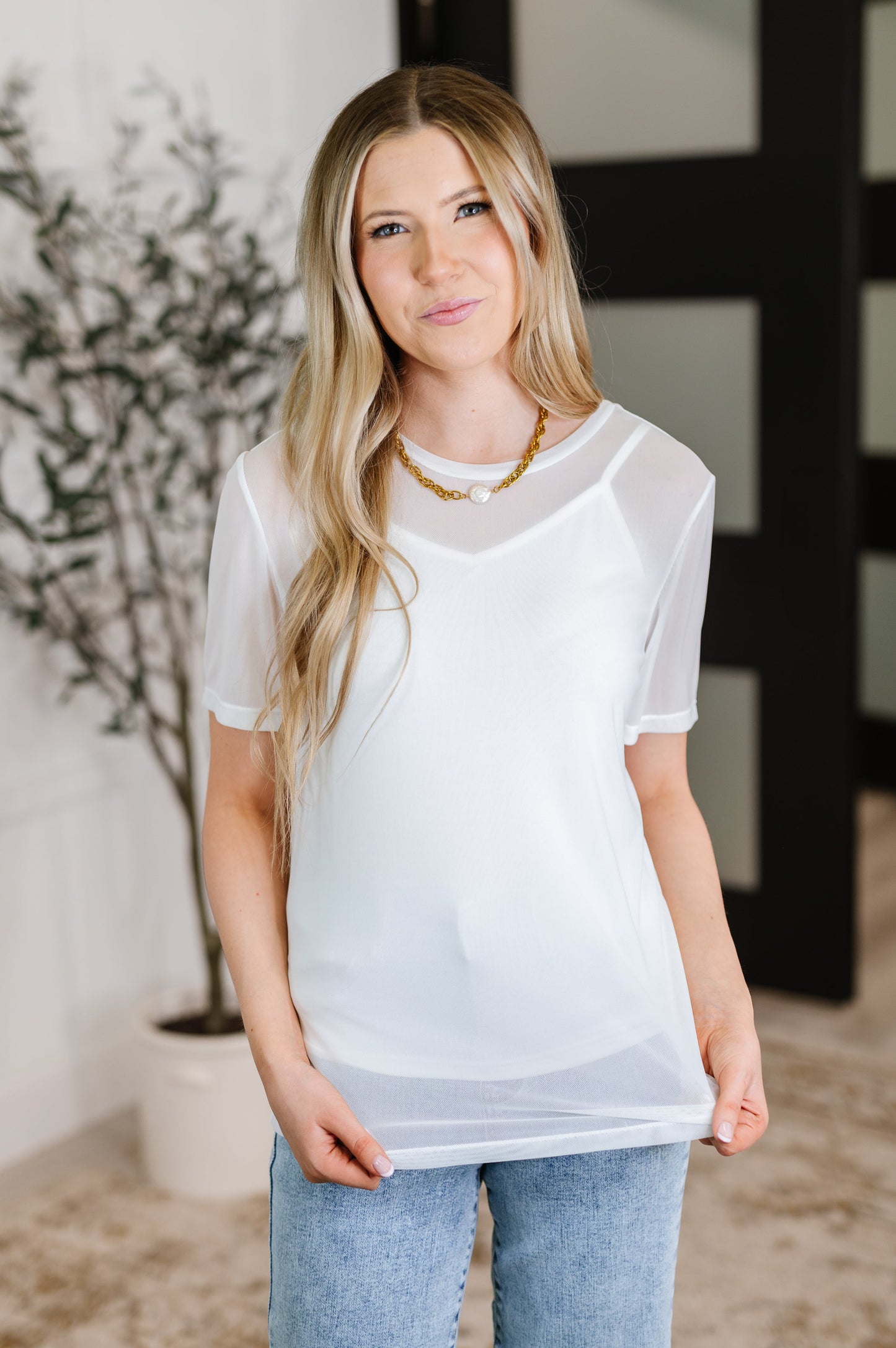 Front view of Marisol Layered Mesh Top styled with jeans.