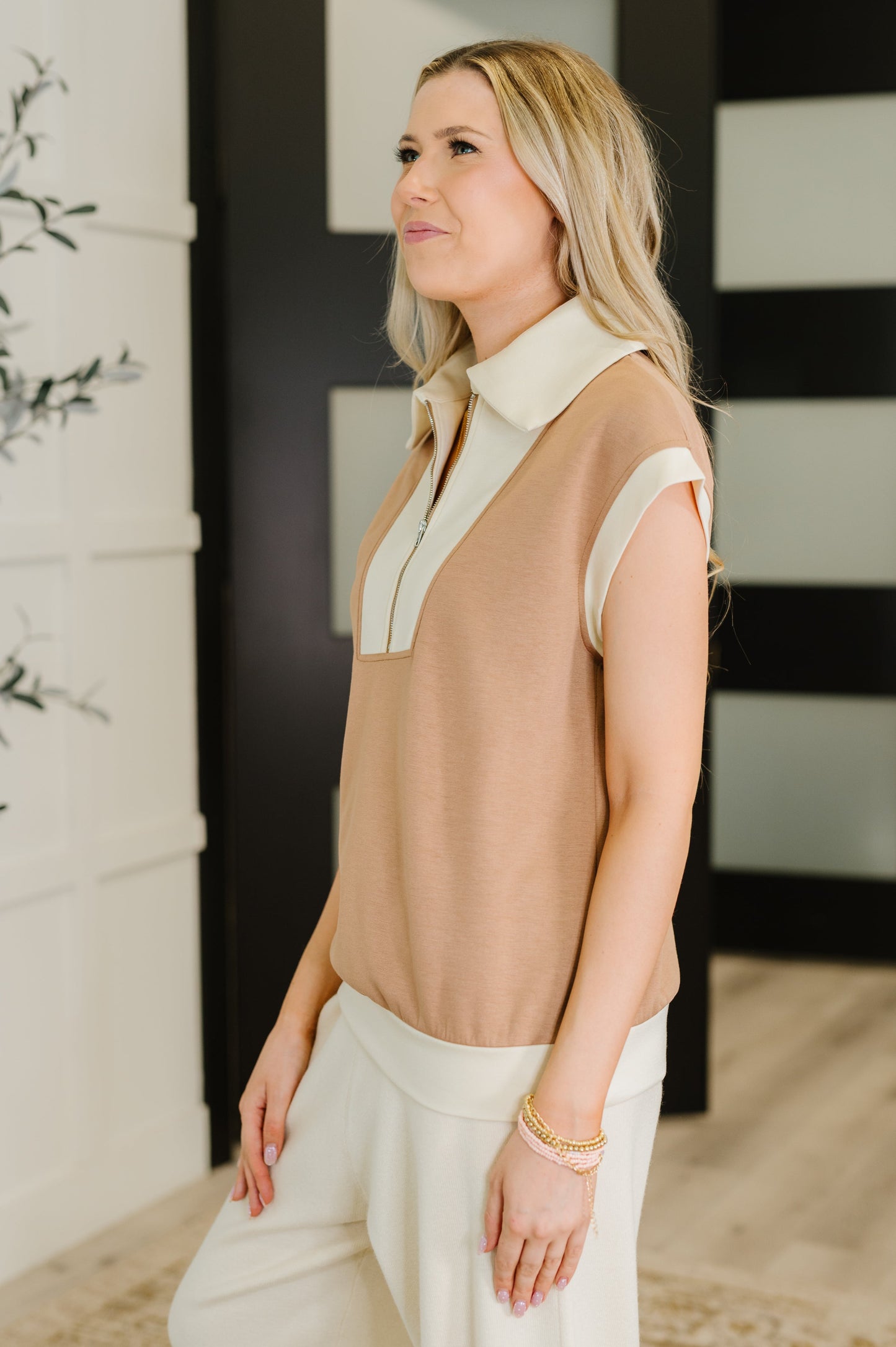 Side profile of Jovie Color Block Half Zip Top highlighting scuba knit fabric and half zip neckline.