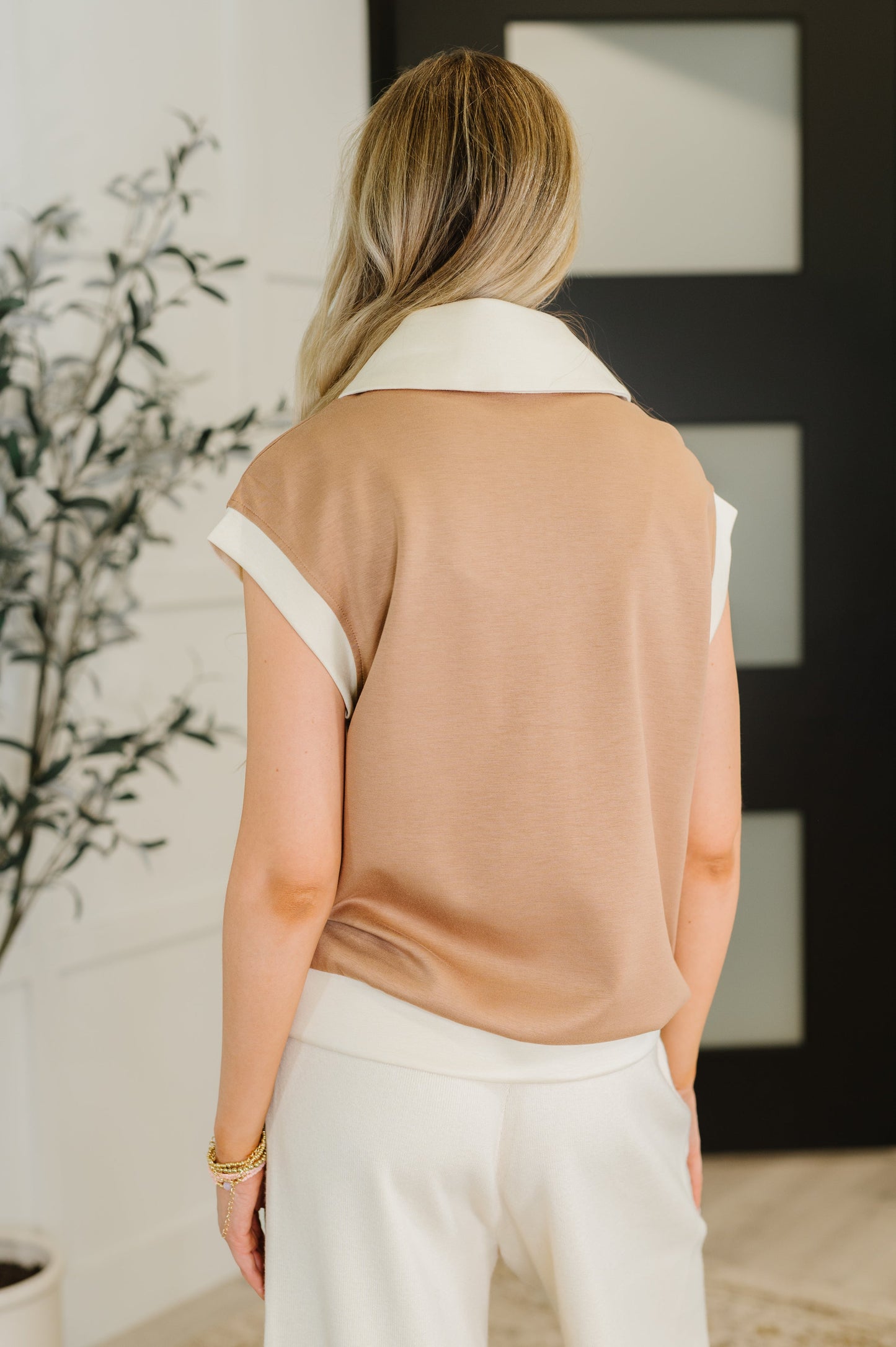 Back view of Jovie Color Block Half Zip Top in camel and beige color block with banded hemline.