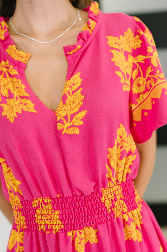 Close-up view of Lainey V-Neck Dress showing the textured woven fabric, ruffled V-neck collar, smocked elastic waist, and flutter short sleeve.