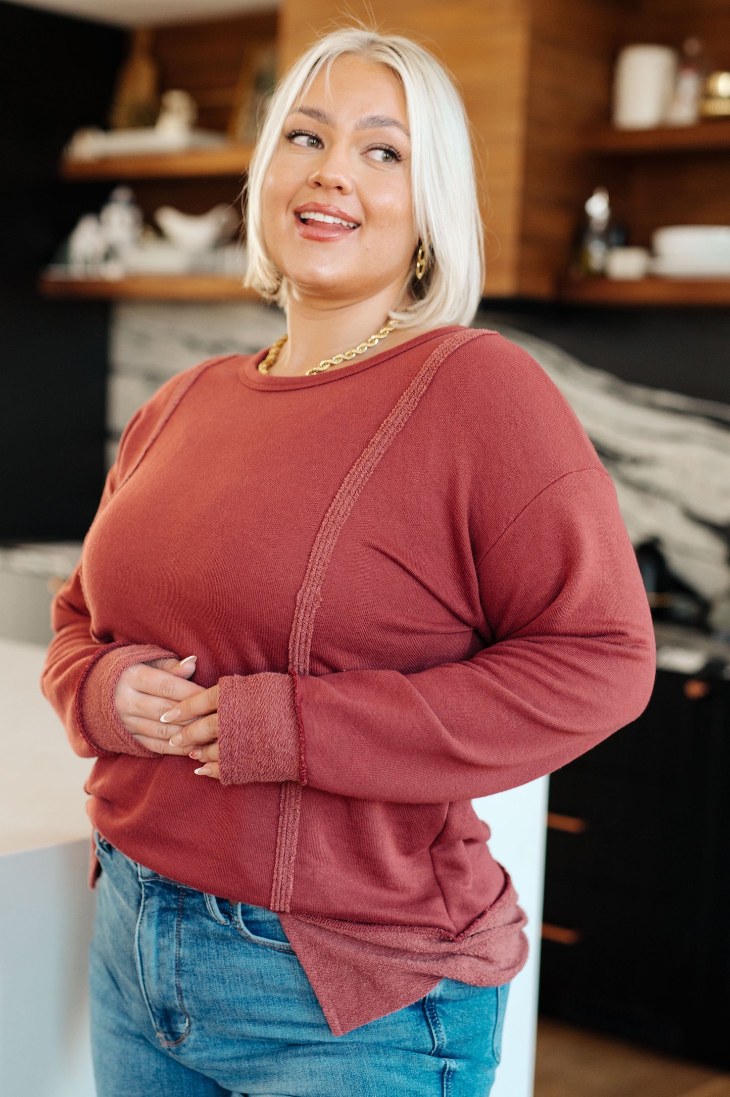 Plus size front view of Taya Pullover in red French terry with dropped shoulders and exposed seams.