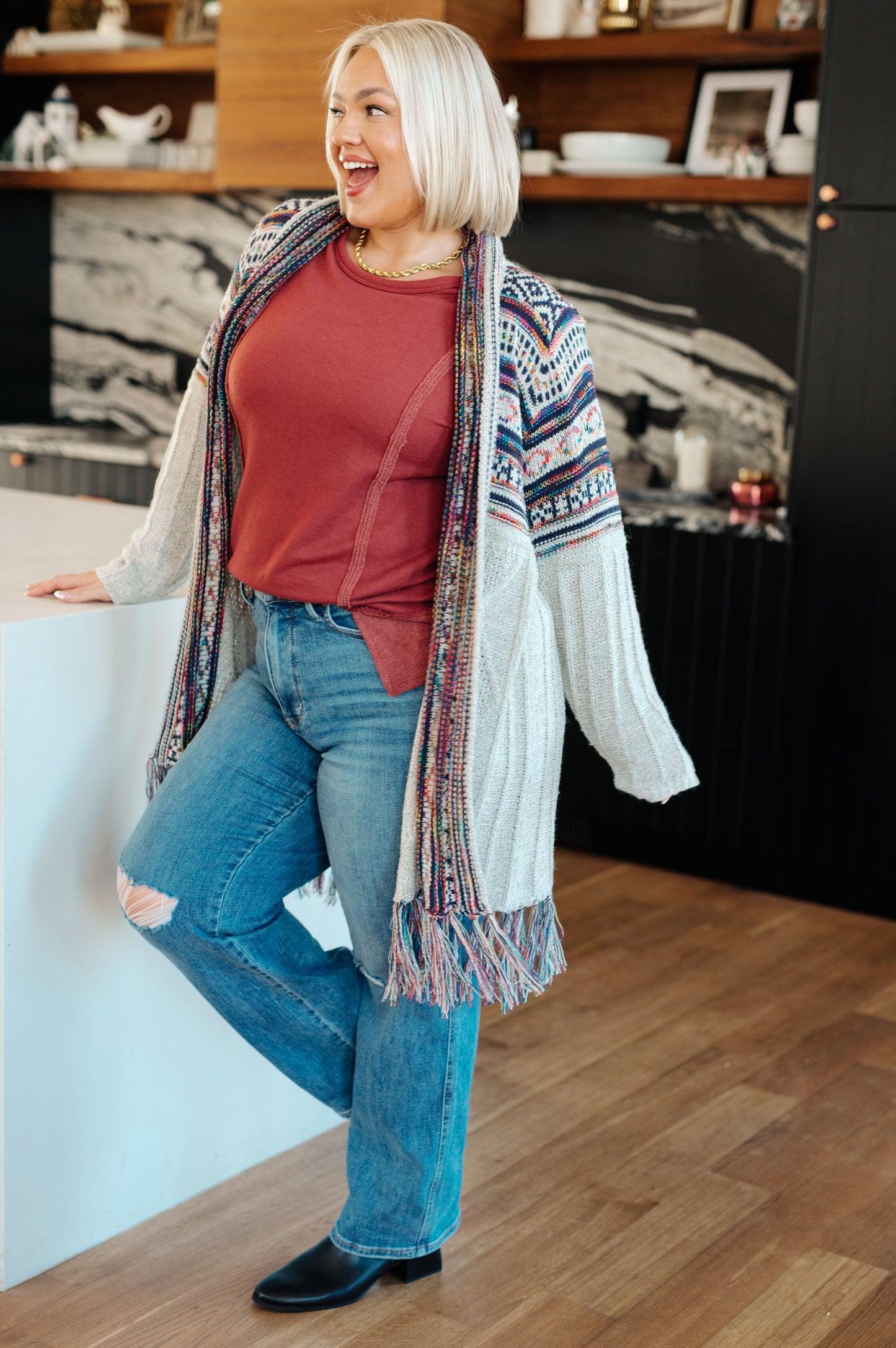 Plus size full body side view of Taya Pullover in red French terry with reverse fabric details.