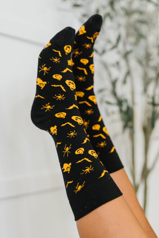 Woman wearing Wicked Walk Quarter Socks with spooky pumpkin, ghost, bat, and spider design