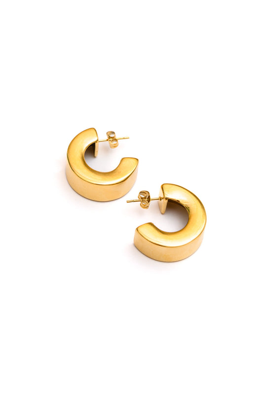 Close-up of Wes Chunky Gold Hoops showing bold silhouette and polished gold finish.