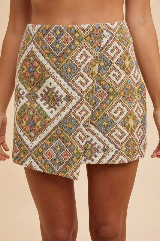 Front view of Regina Jacquard Wrap Mini Skirt in yellow green geometric print with high waist and chic woven detailing.