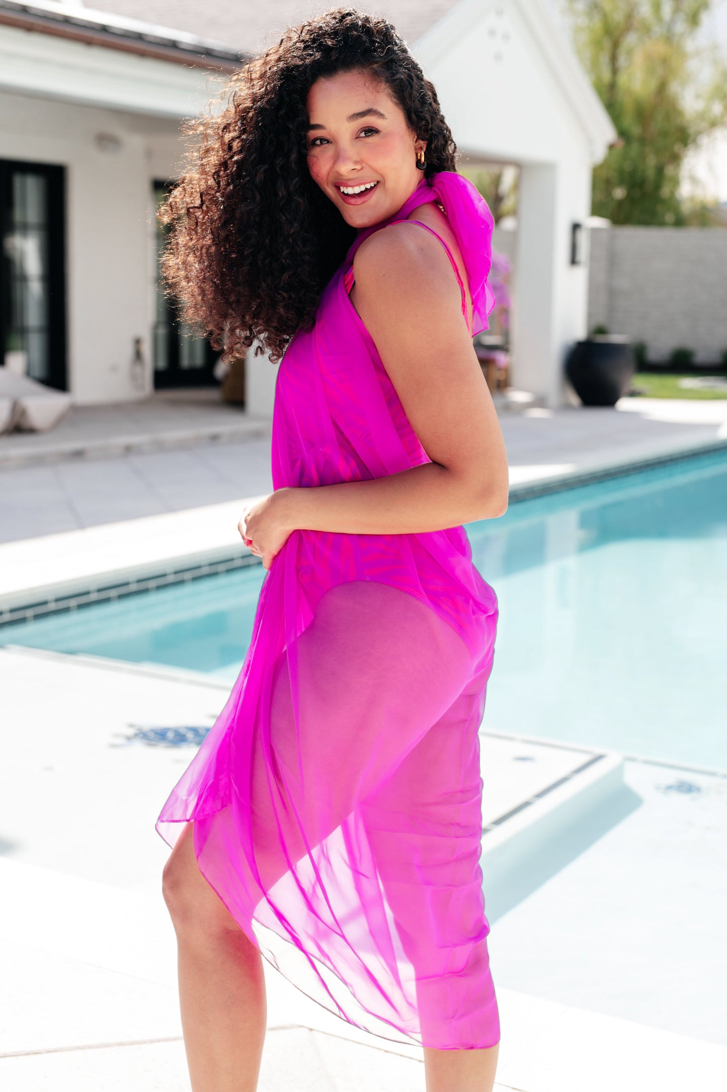 Side view of Wrapped in Summer Swim Cover styled as halter dress, sheer pink mesh over swimsuit.