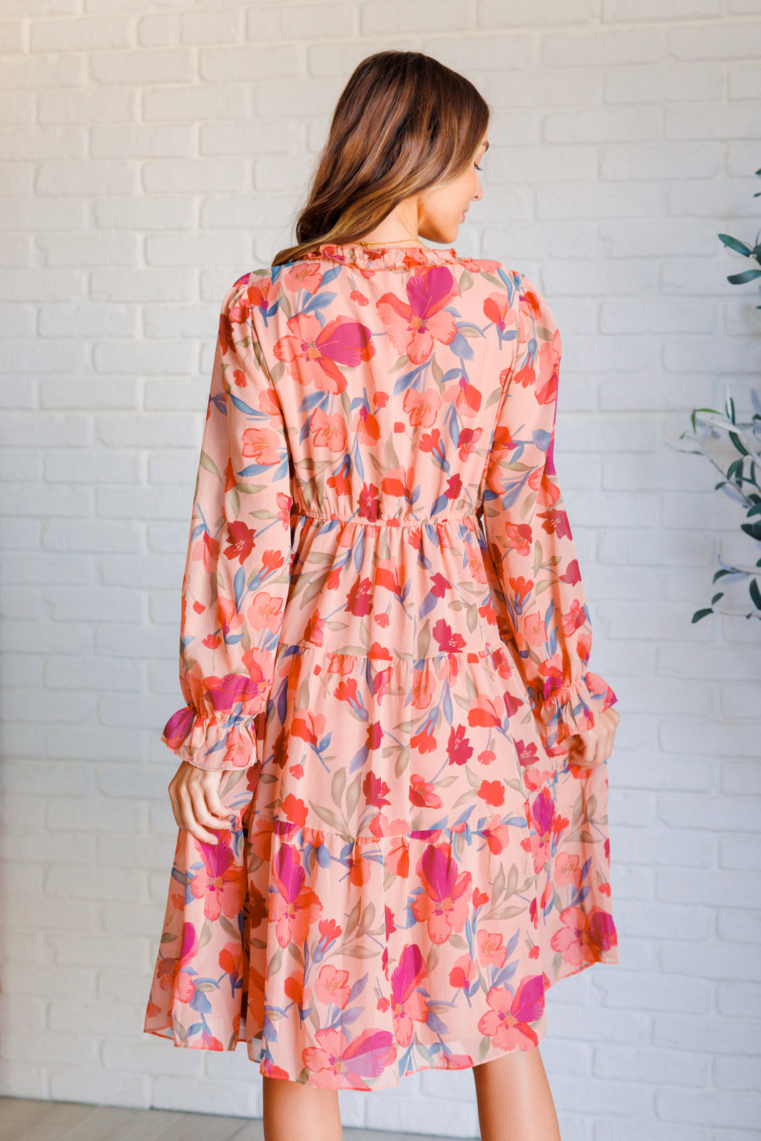 Back view of Maci Floral Midi Dress with tiered skirt and flowy floral chiffon fabric