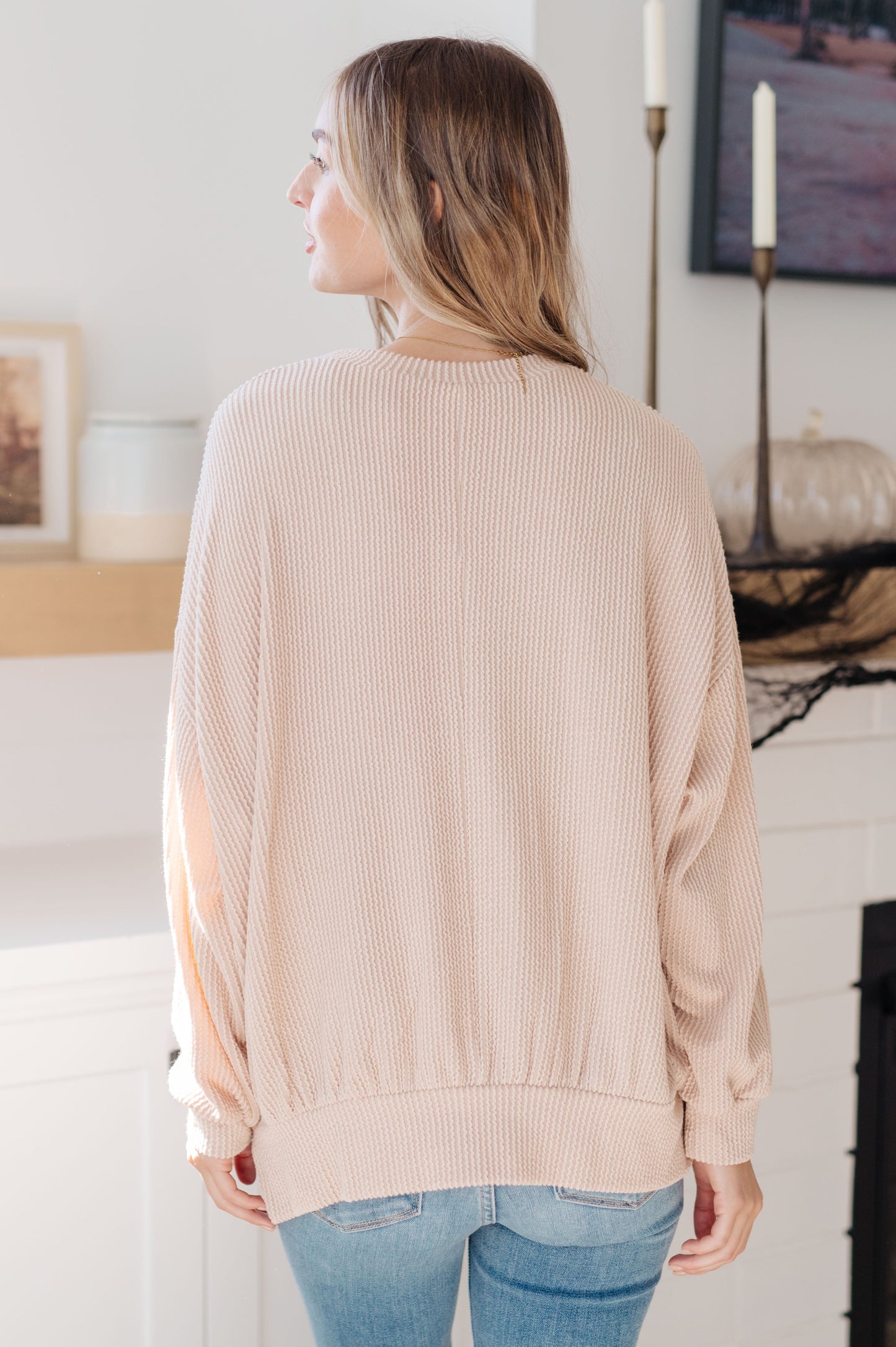 Back of Holly Pullover showing ribbed knit texture and straight hemline.