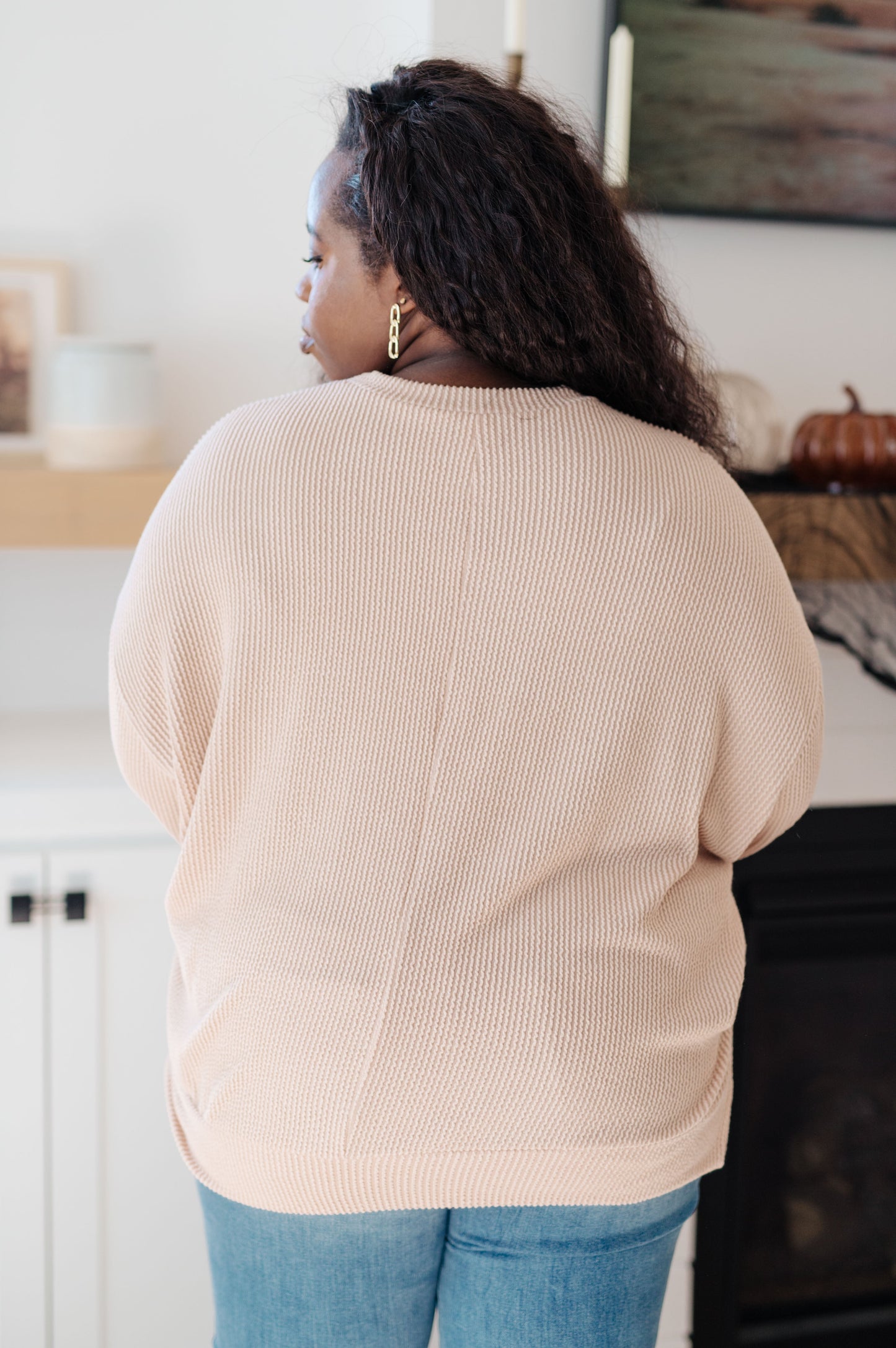 Back of plus size model wearing Holly Pullover highlighting relaxed fit.