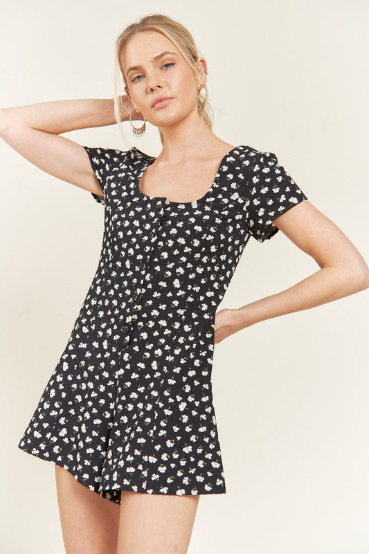 Front view of Xiomara Plus Size Floral Romper with navy floral print, button-down front, and smocked back.