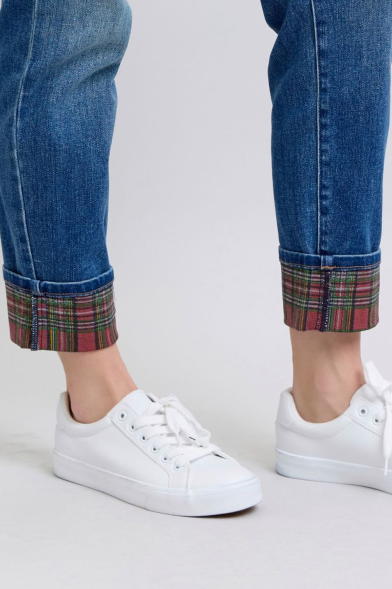 Close up of Logan Plaid Cuff Straight Leg Jeans highlighting red and green plaid cuff against medium wash denim.