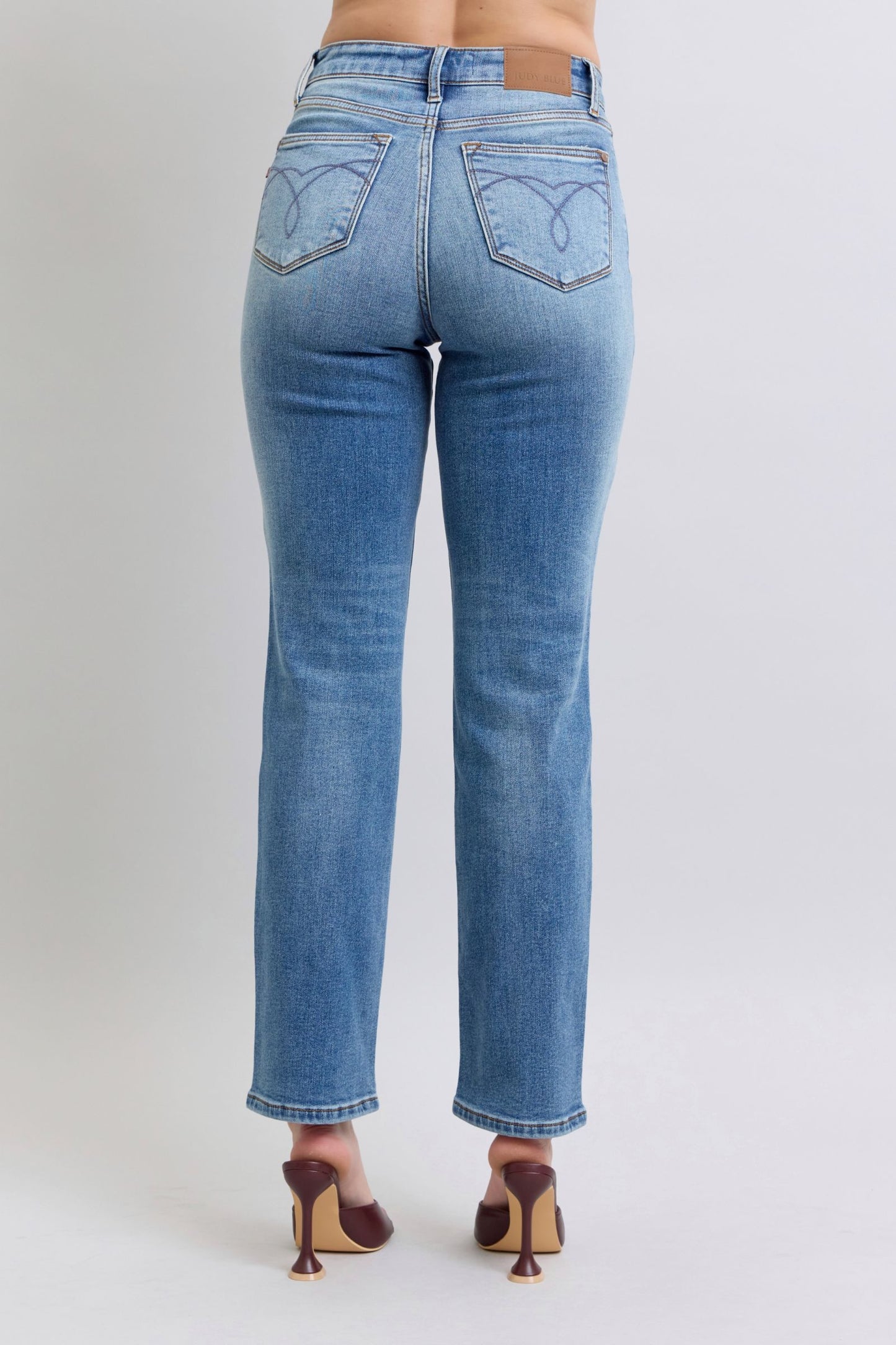 Back view of Della Judy Blue straight jeans, medium wash with thermal texture and functional back pockets.