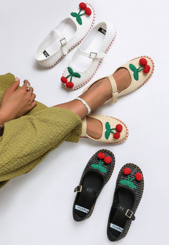 Top view of Brunch Date Mary Jane Flats in beige, white, and black with cherry accents.