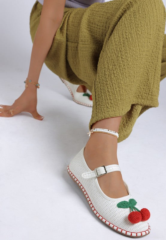 Front side view of white Brunch Date Mary Jane Flats featuring cherry detail, woven texture, and buckle strap.