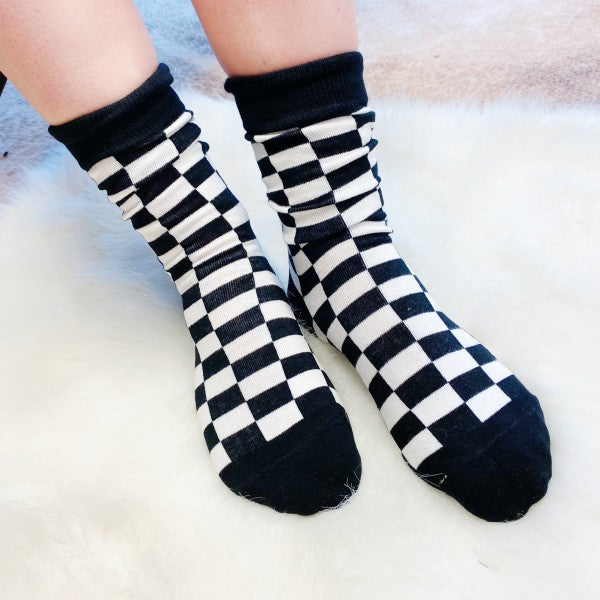 Woman wearing black-and-white checkered socks from Insiders Only Set.