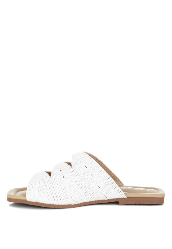 Inside side view of white Daisy Doe raffia flat highlighting the slip-on design and detailed raffia cut work.