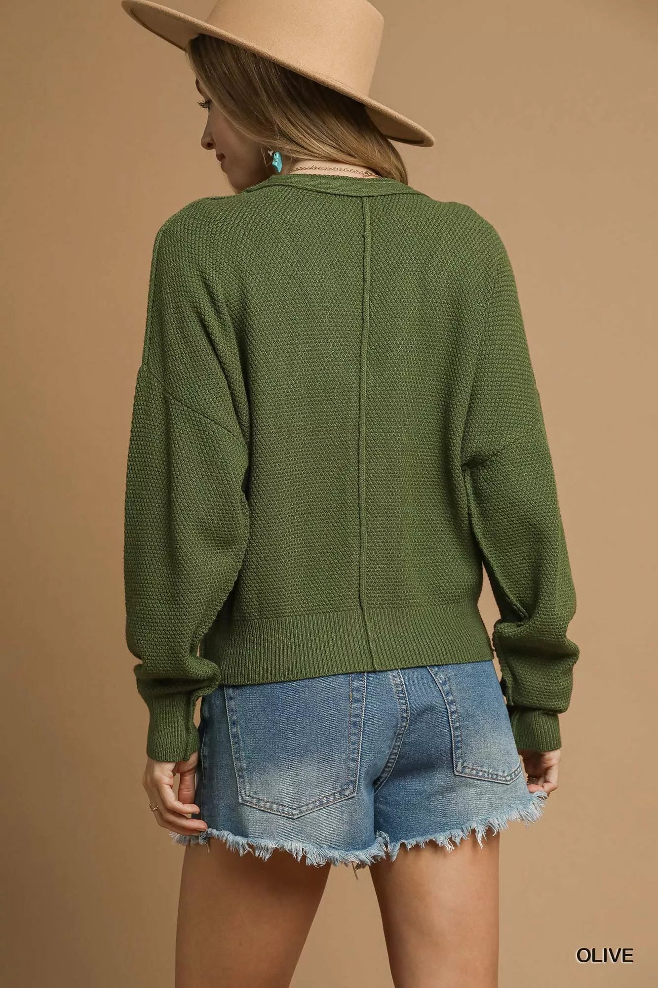 Back view of Uma Olive Cable Knit Cardigan with long sleeves.
