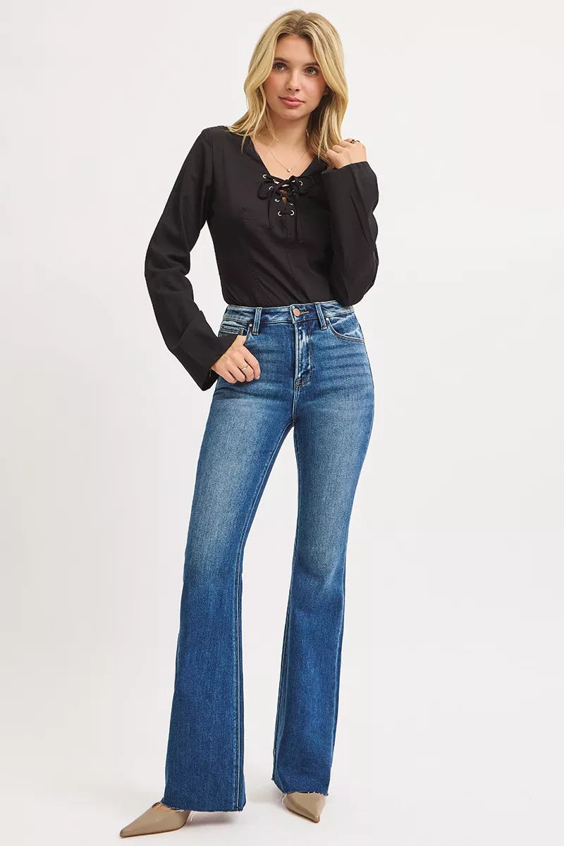 Model styling Seraphina High Rise Flare Jeans dark wash with heels, trendy fit.