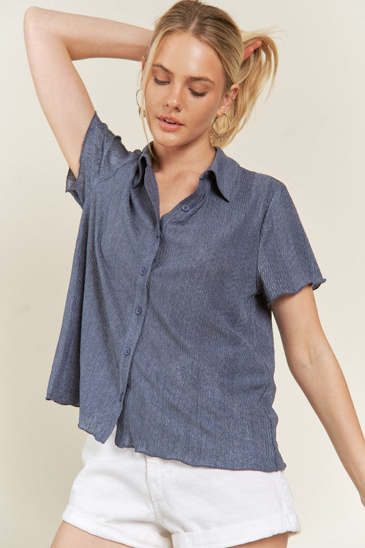 Denim blue collared button down shirt with textured finish.
