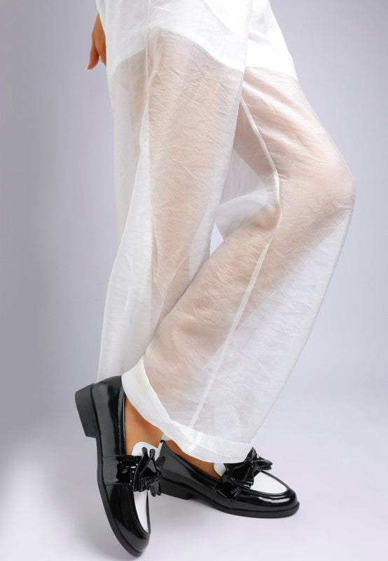 Model top angle view of Araminta Classic Chunky Bow Loafers in Black with soft insole and bow detail