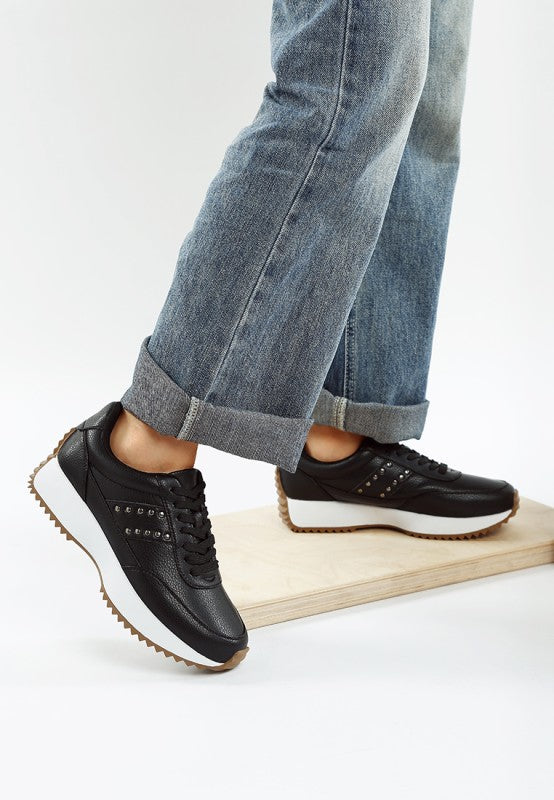 Side view of black Athion Studded Leather Sneakers with gum lug sole detail