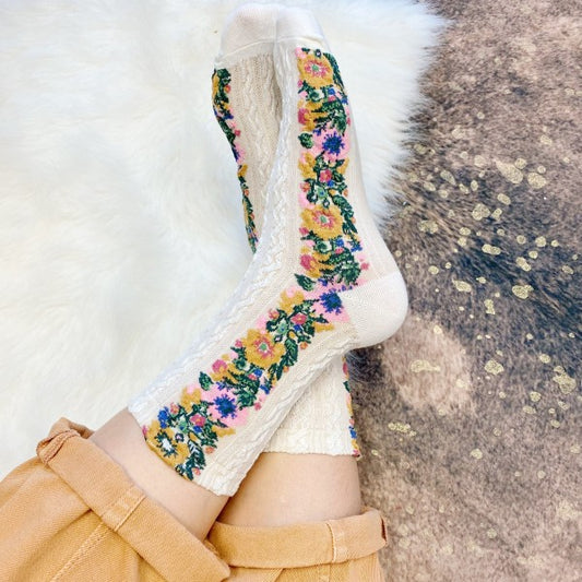 Woman wearing white Noble Floral Beauty Socks styled with intricate floral detail.