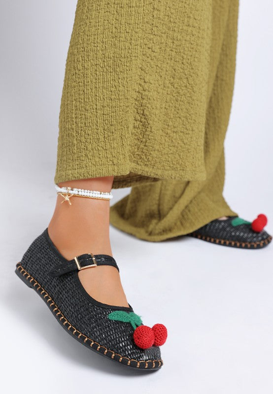 Side view of black Brunch Date Mary Jane Flats with pants, featuring woven cherry detail and a casual flat sole.