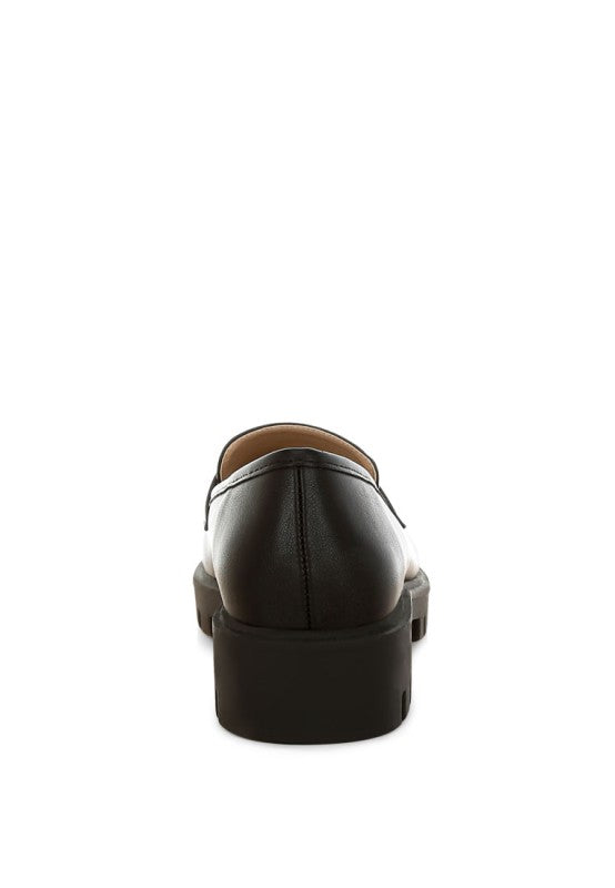 Peridot Chunky Loafers in black showing raised heel and durable lug sole.