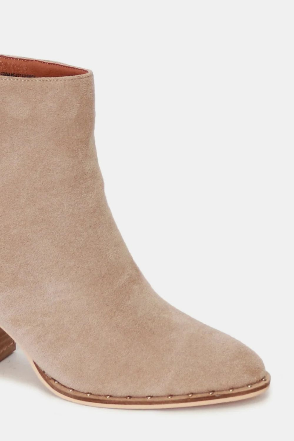 Close up of Callia taupe suede ankle booties, showing fine suede texture, zipper closure, and polished point toe.