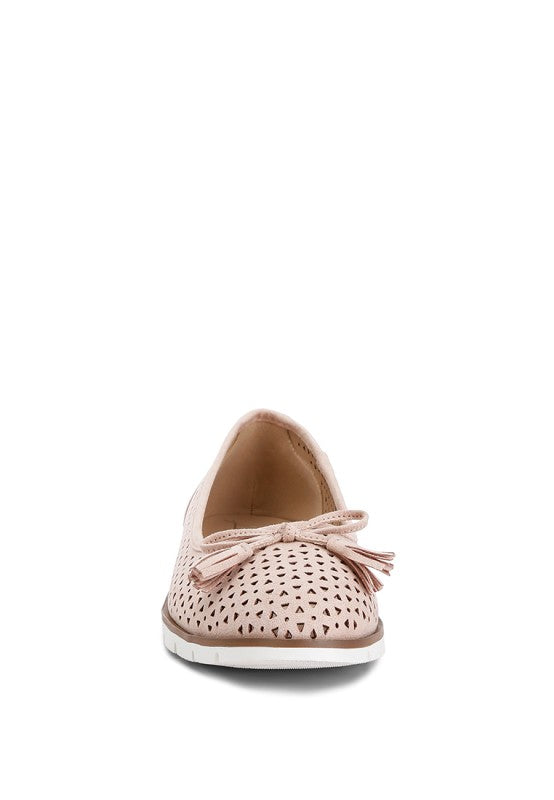Front view of blush Pacer vegan leather ballerina flats showing the closed round toe and decorative bow detail.