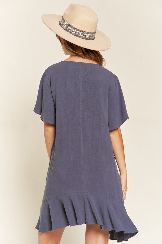Back view of model wearing Cement Gentry Curvy Tiered Ruffle Mini Dress, highlighting tiered ruffles and relaxed fit.