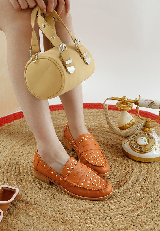 Front angle of woman wearing Tan Oglavia Studded Leather Loafers.
