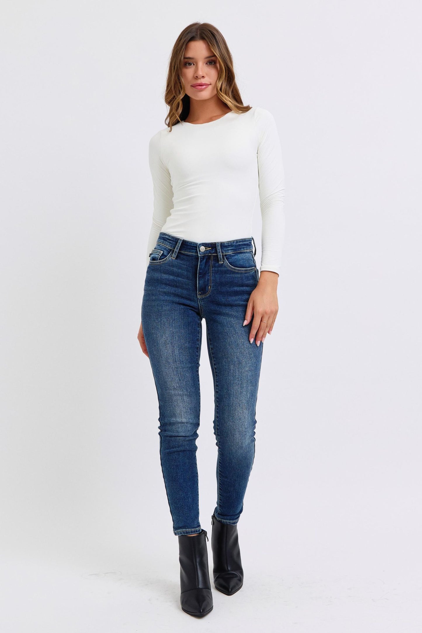 Full body view of Sadie Curvy Plus Skinny Jeans styled with casual top and boots.