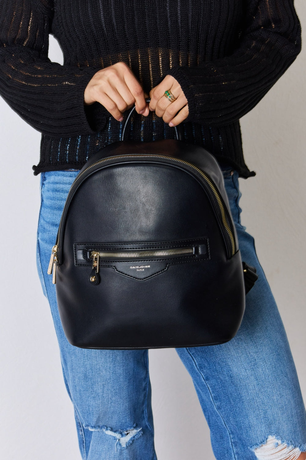 Front view of Garris black vegan leather backpack with sleek medium-size design.