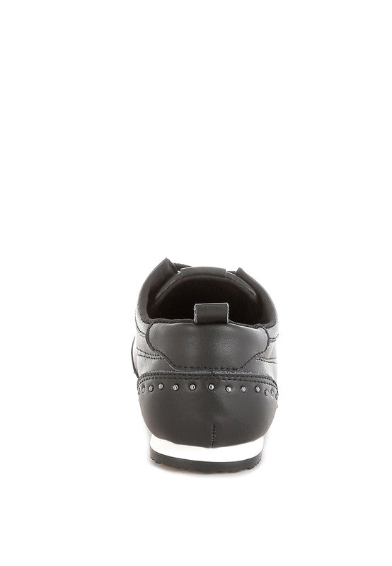 Black Odaya Studded Leather Sneakers by Rag Company, back view showing pull tab and contrast sole detail.