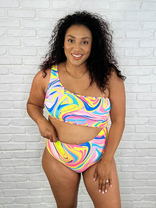 Plus size woman in Corfu Marble Cutout Swimsuit, side view, bold print.