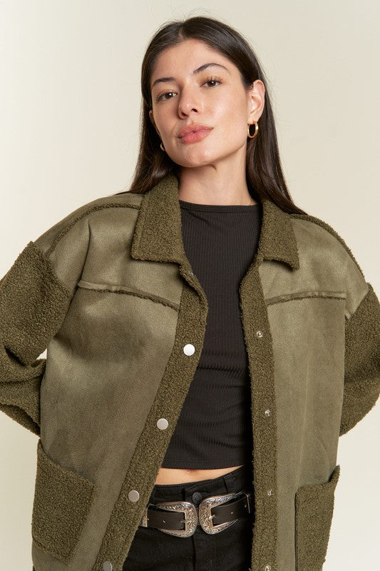 Close-up of olive Galina faux suede sherpa jacket showing plush collar and snap closure.