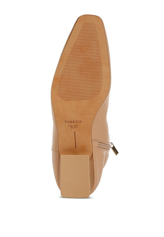 Bottom view of Obita Leather Ankle Boots in beige showing outsole design and heel structure
