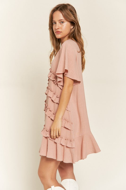 Side view of Gentry Tiered Ruffle Mini Dress in mauve highlighting tiered layers and airy shape.